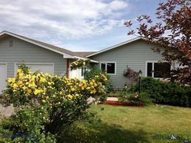 218 W Armitage St, Ennis, MT 59729 - view of front facade with a front yard and an attached garage