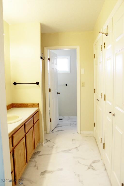 bathroom with vanity and marble finish floor