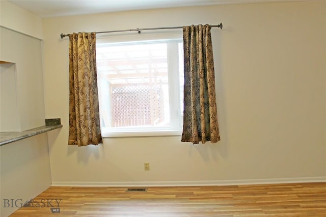 spare room featuring light wood-type flooring