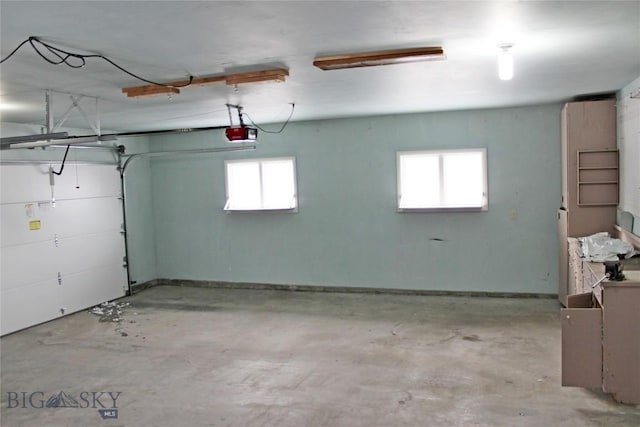 garage with baseboards and a garage door opener