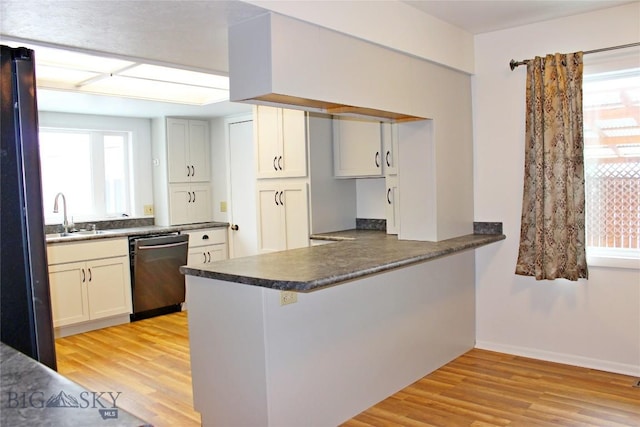 kitchen featuring sink, kitchen peninsula, dishwasher, and light wood-type flooring