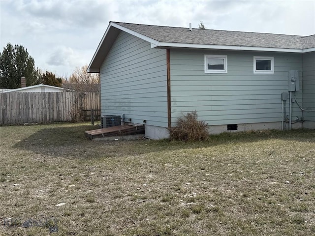 view of home's exterior featuring central AC, fence, a yard, and crawl space