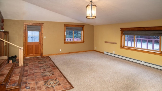 carpeted entrance foyer featuring a baseboard radiator, a healthy amount of sunlight, and vaulted ceiling