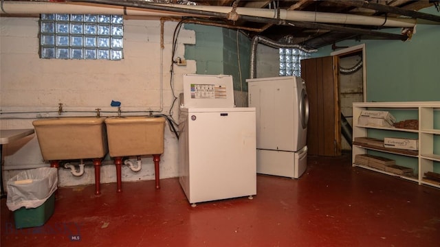 basement featuring sink and washer and clothes dryer