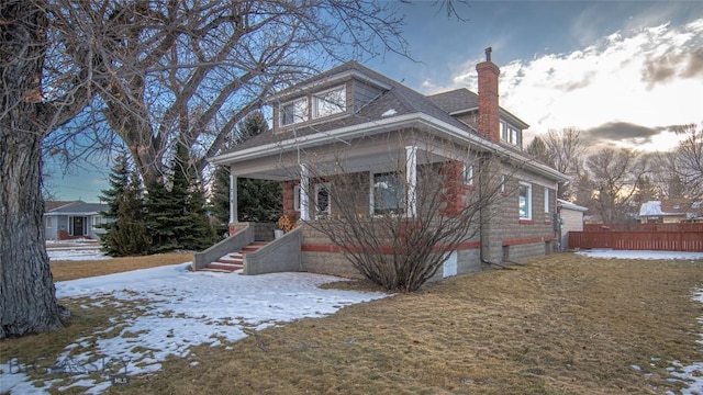 view of front of property featuring a yard and covered porch