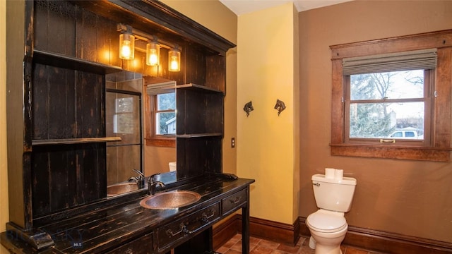 bathroom with vanity, an enclosed shower, and toilet