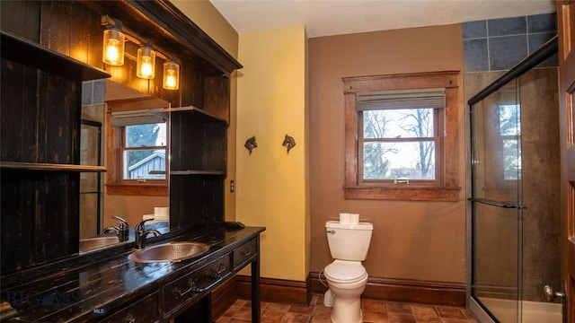 bathroom with vanity, toilet, and an enclosed shower