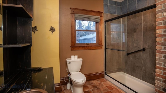 bathroom with tile patterned floors, toilet, and walk in shower