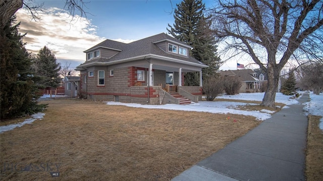 bungalow-style house featuring a porch and a lawn