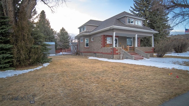 bungalow-style house featuring a lawn and a porch