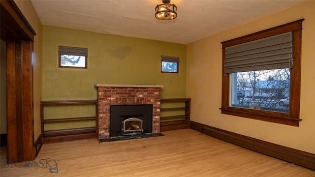 living room with a baseboard radiator and light wood-type flooring