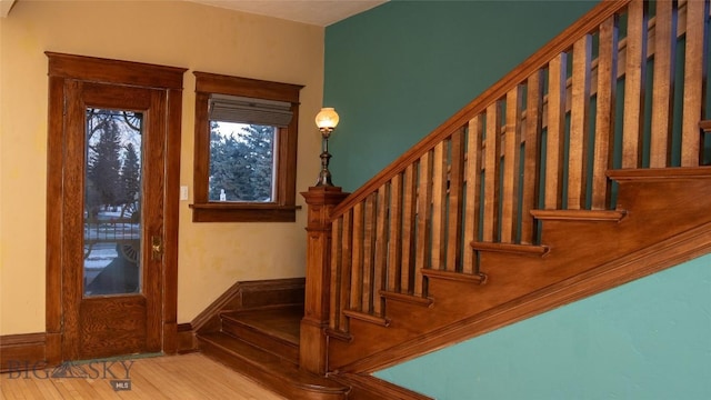 stairway with hardwood / wood-style floors