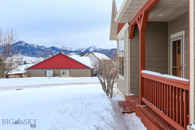 snowy yard featuring a mountain view