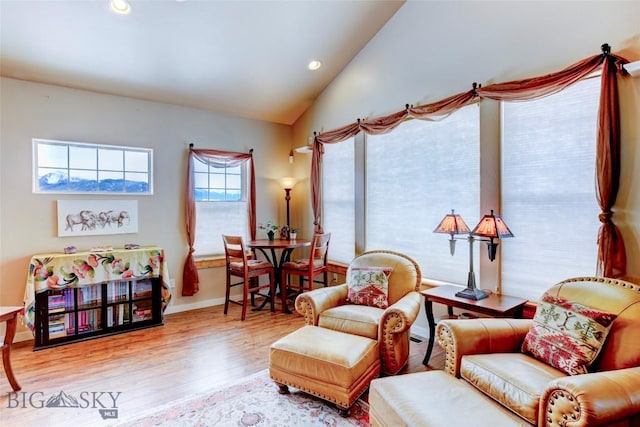 sitting room with recessed lighting, vaulted ceiling, baseboards, and wood finished floors