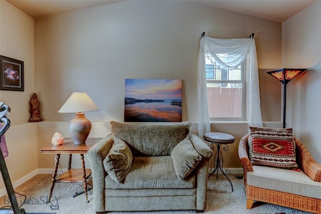 sitting room with carpet floors, lofted ceiling, and baseboards