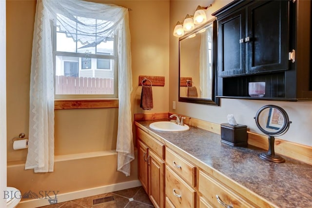 bathroom with vanity, tile patterned flooring, visible vents, and baseboards