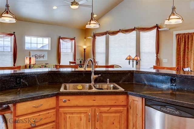 kitchen featuring a sink, decorative light fixtures, stainless steel dishwasher, and lofted ceiling