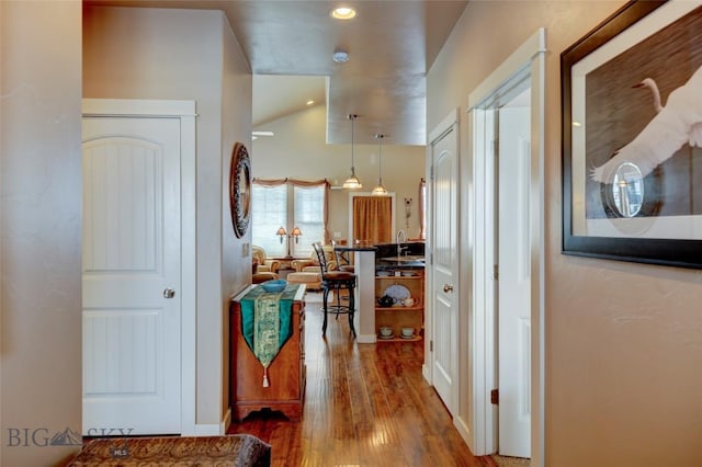 corridor featuring wood finished floors and recessed lighting