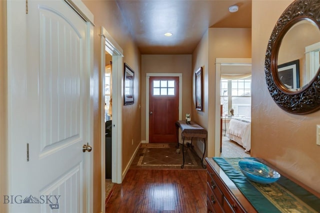 doorway to outside featuring dark wood-style floors and baseboards