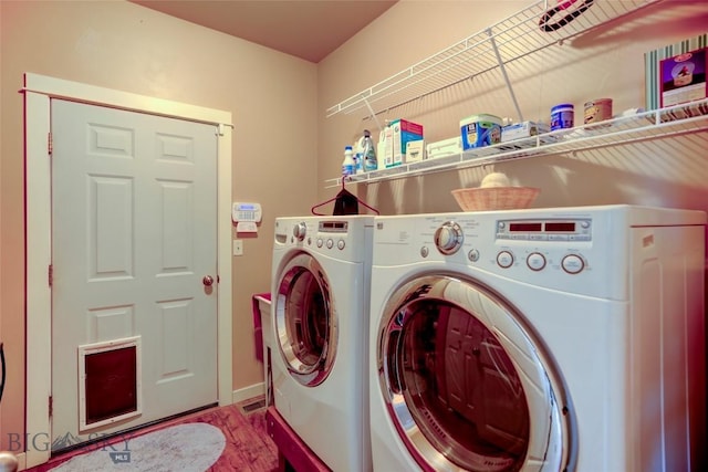 clothes washing area featuring laundry area, baseboards, and separate washer and dryer