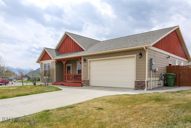 craftsman-style house with concrete driveway, a front lawn, board and batten siding, an attached garage, and fence