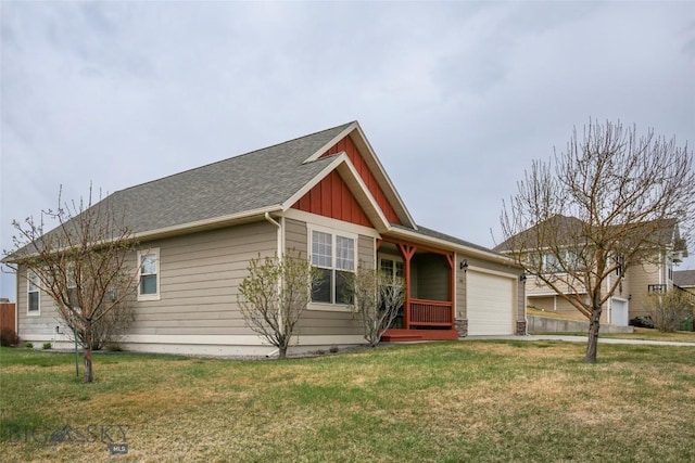 view of front of house with a front yard, board and batten siding, a shingled roof, and a garage