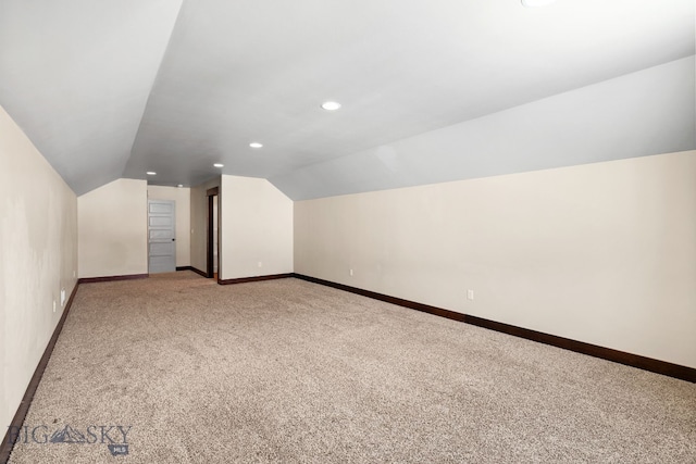 bonus room featuring lofted ceiling and carpet flooring