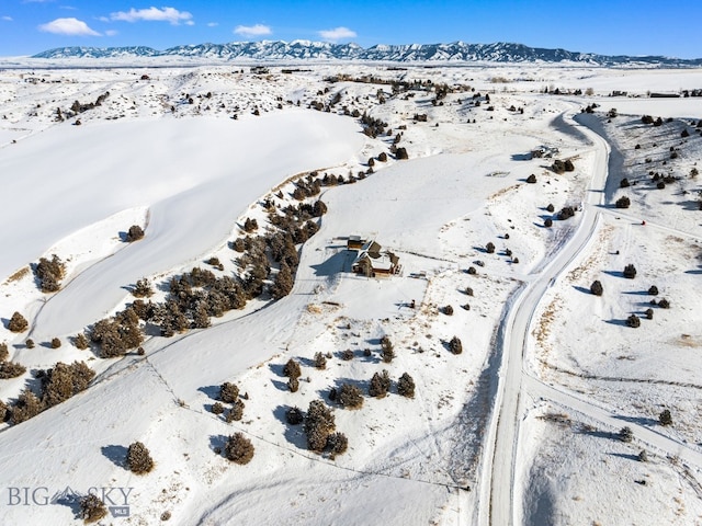 snowy aerial view featuring a mountain view