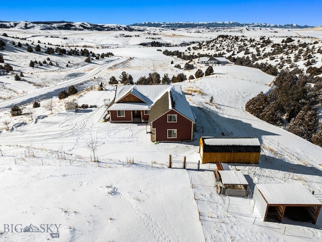 snowy aerial view featuring a mountain view