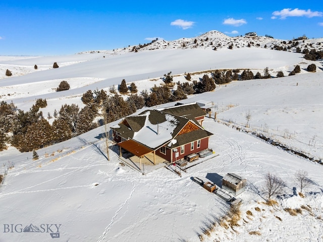 snowy aerial view with a mountain view