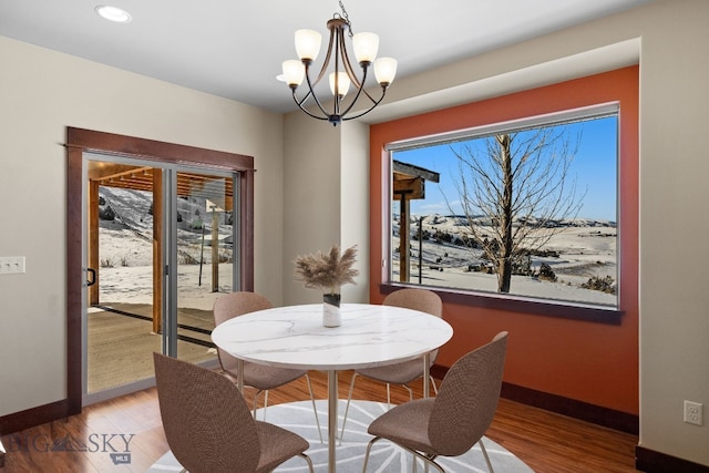 dining area with an inviting chandelier and wood-type flooring