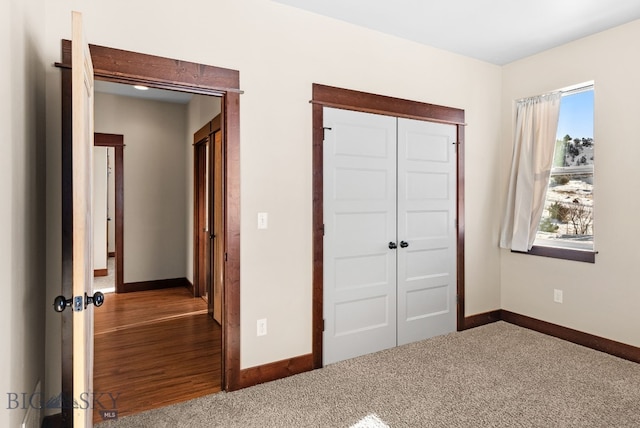 unfurnished bedroom with a closet and carpet flooring