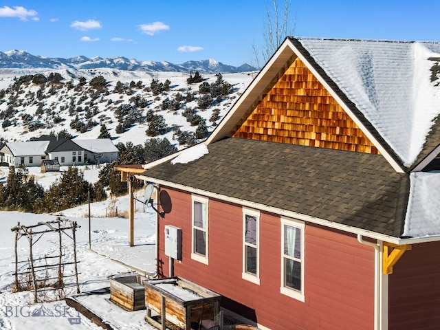 view of snowy exterior featuring a mountain view