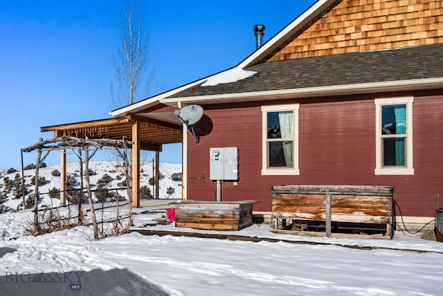 snow covered house featuring a mountain view