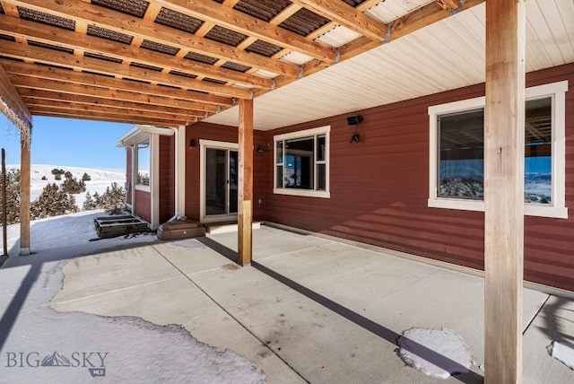 snow covered patio featuring a mountain view