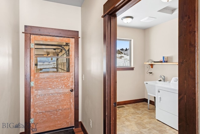 clothes washing area with washer / dryer