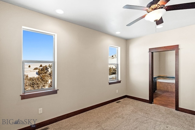 unfurnished bedroom featuring ensuite bathroom, ceiling fan, and carpet