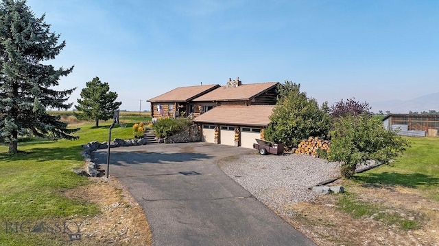 view of front facade featuring a garage and a front lawn