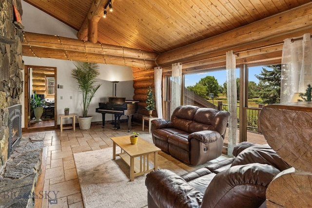 living room featuring wood ceiling, a fireplace, and high vaulted ceiling