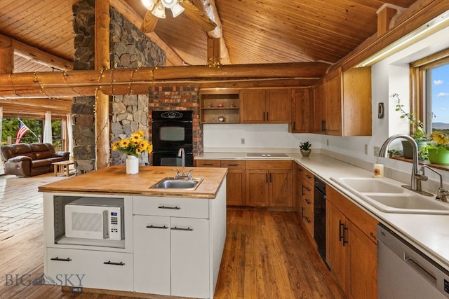 kitchen featuring white cabinetry, wooden counters, sink, and black appliances