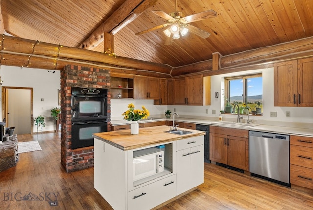 kitchen featuring black double oven, sink, stainless steel dishwasher, and a kitchen island with sink