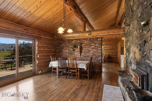 unfurnished dining area with an inviting chandelier, wood-type flooring, lofted ceiling with beams, a mountain view, and log walls