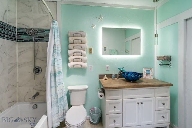 full bathroom with shower / tub combo with curtain, vanity, and toilet