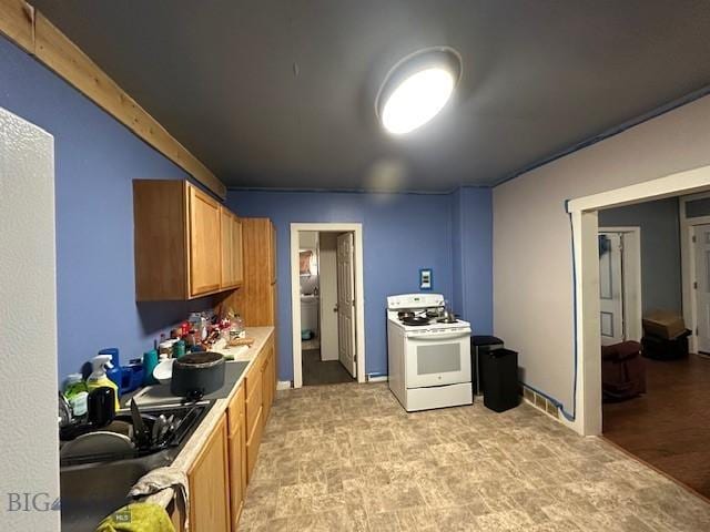 kitchen with sink and white electric range oven