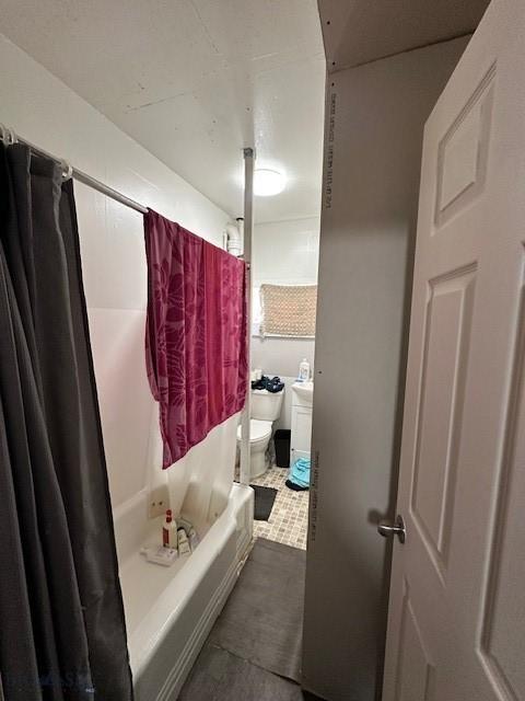 bathroom featuring shower / bath combo, tile patterned floors, and toilet