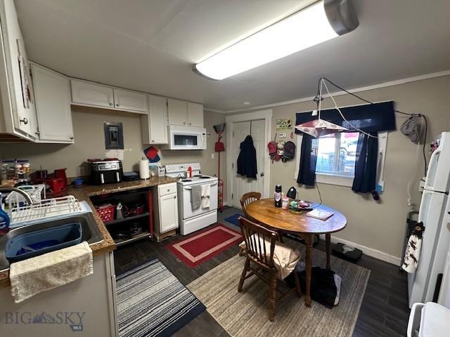 kitchen with crown molding, sink, white appliances, and white cabinets