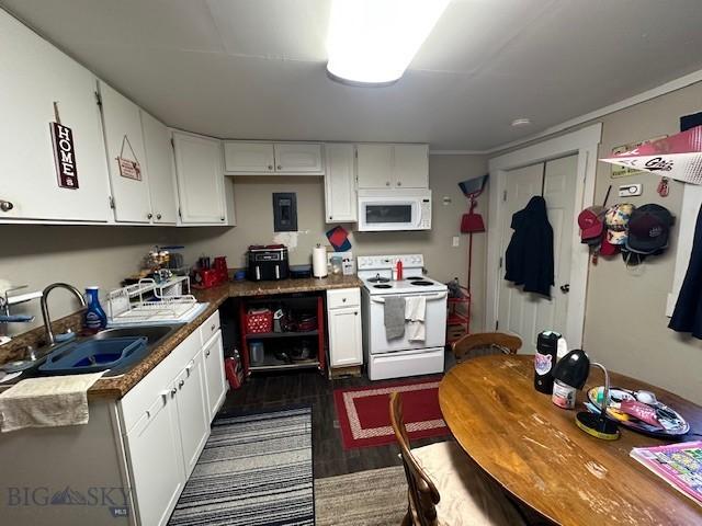 kitchen with white cabinetry, sink, white appliances, and dark hardwood / wood-style floors