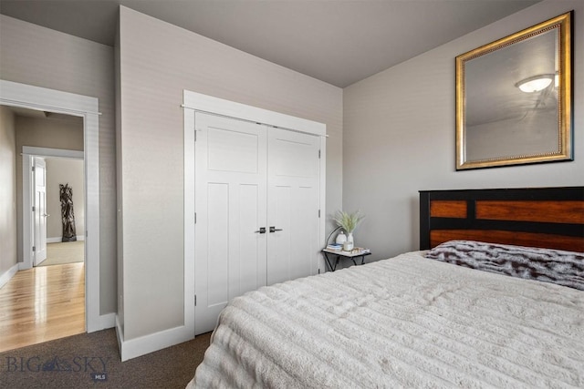 bedroom featuring a closet and dark colored carpet