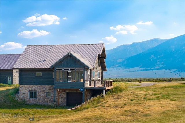 75 Madison Trl, Cameron, MT 59720 - back of property with a garage, a mountain view, a yard, and a sunroom