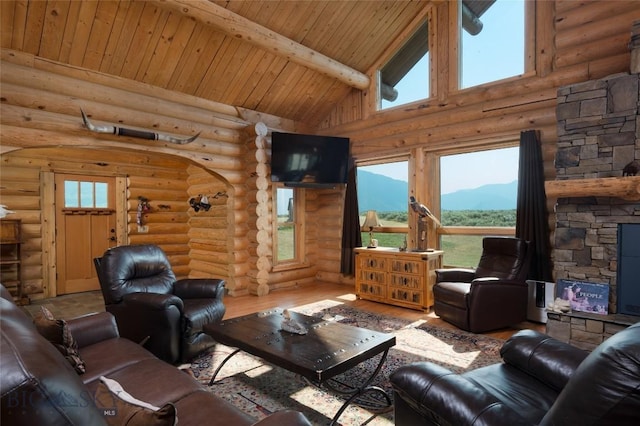 75 Madison Trl, Cameron, MT 59720 - living room featuring a healthy amount of sunlight, hardwood / wood-style floors, a fireplace, and beamed ceiling